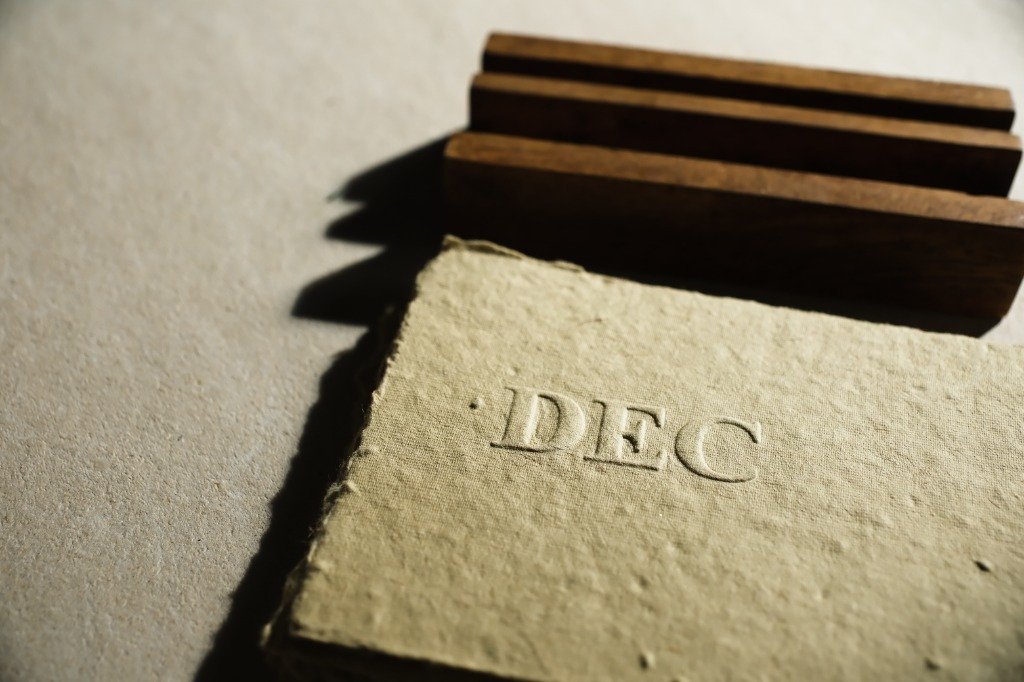 hemp paper og hemp Macro detail of blind debossed DEC month header on deckle edge seed hemp paper